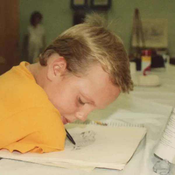 Ryan Hudson-Peralta Drawing an eagle on paper with a pen